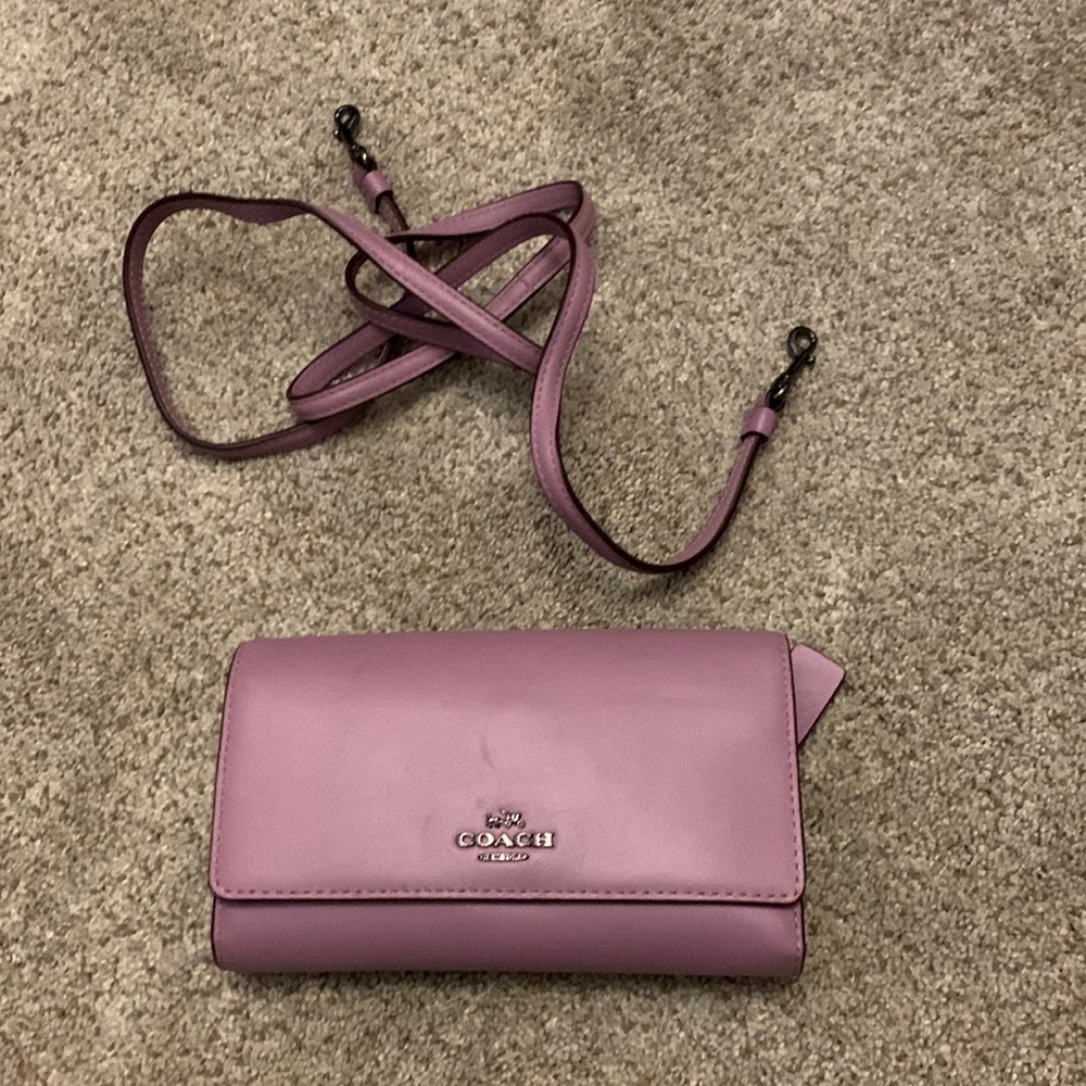 Small coach clutch with removable strap.